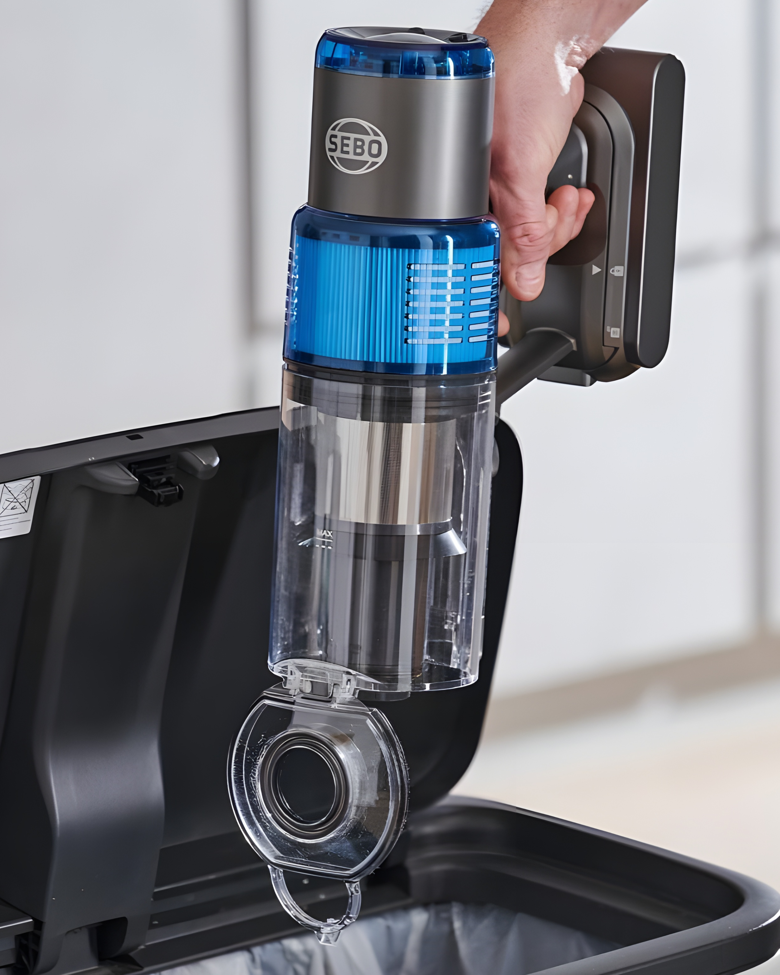 SEBO Balance A1 dust canister emptying into trash can