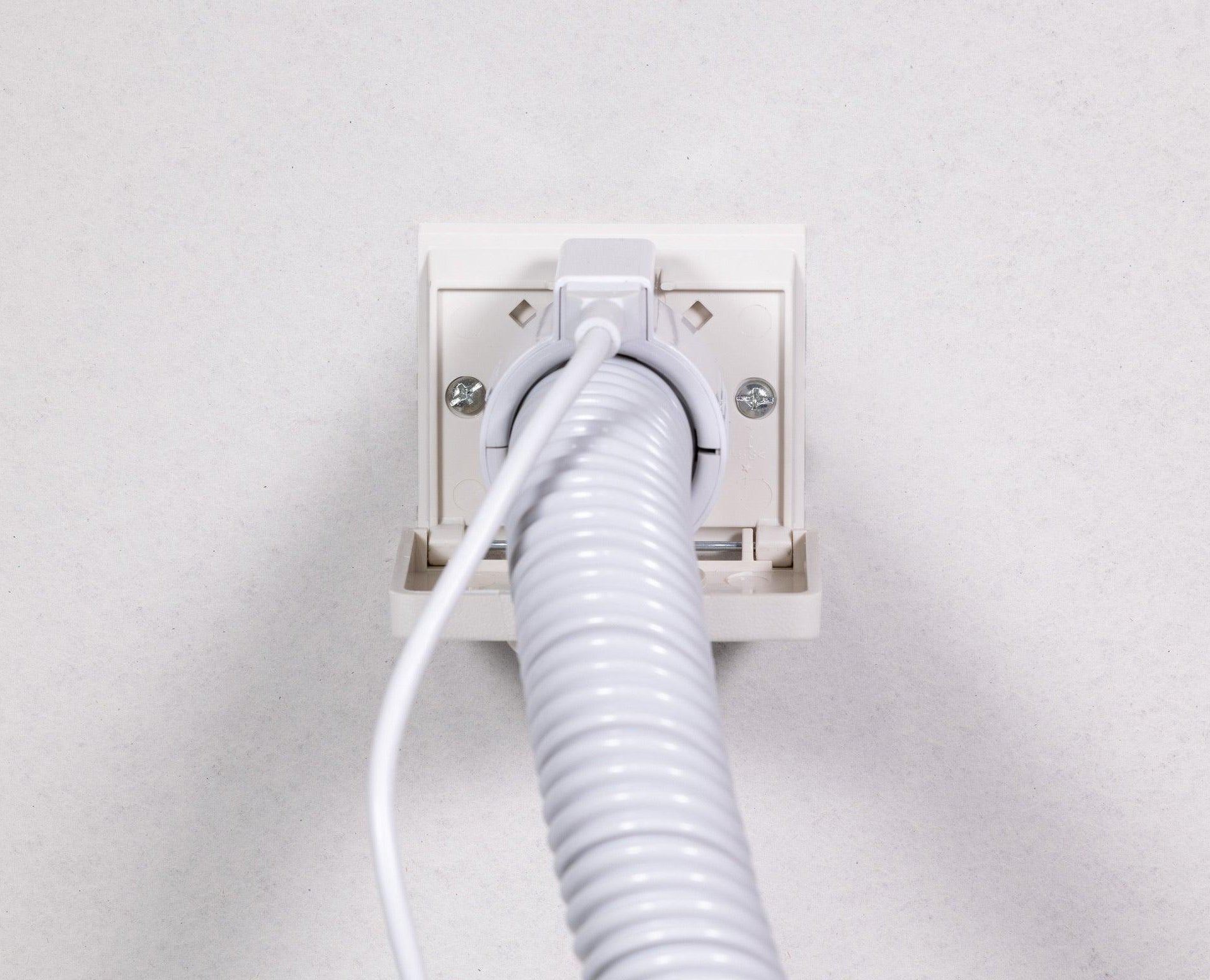 Nutone wall inlet with Nutone hose attached giving power from a local electrical outlet to bring power to the powerhead for carpets