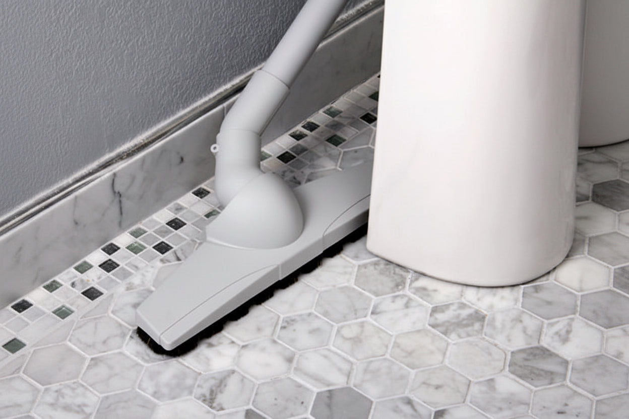 Axis floor brush on Octagon white tile floor showing how to clean behind a sink