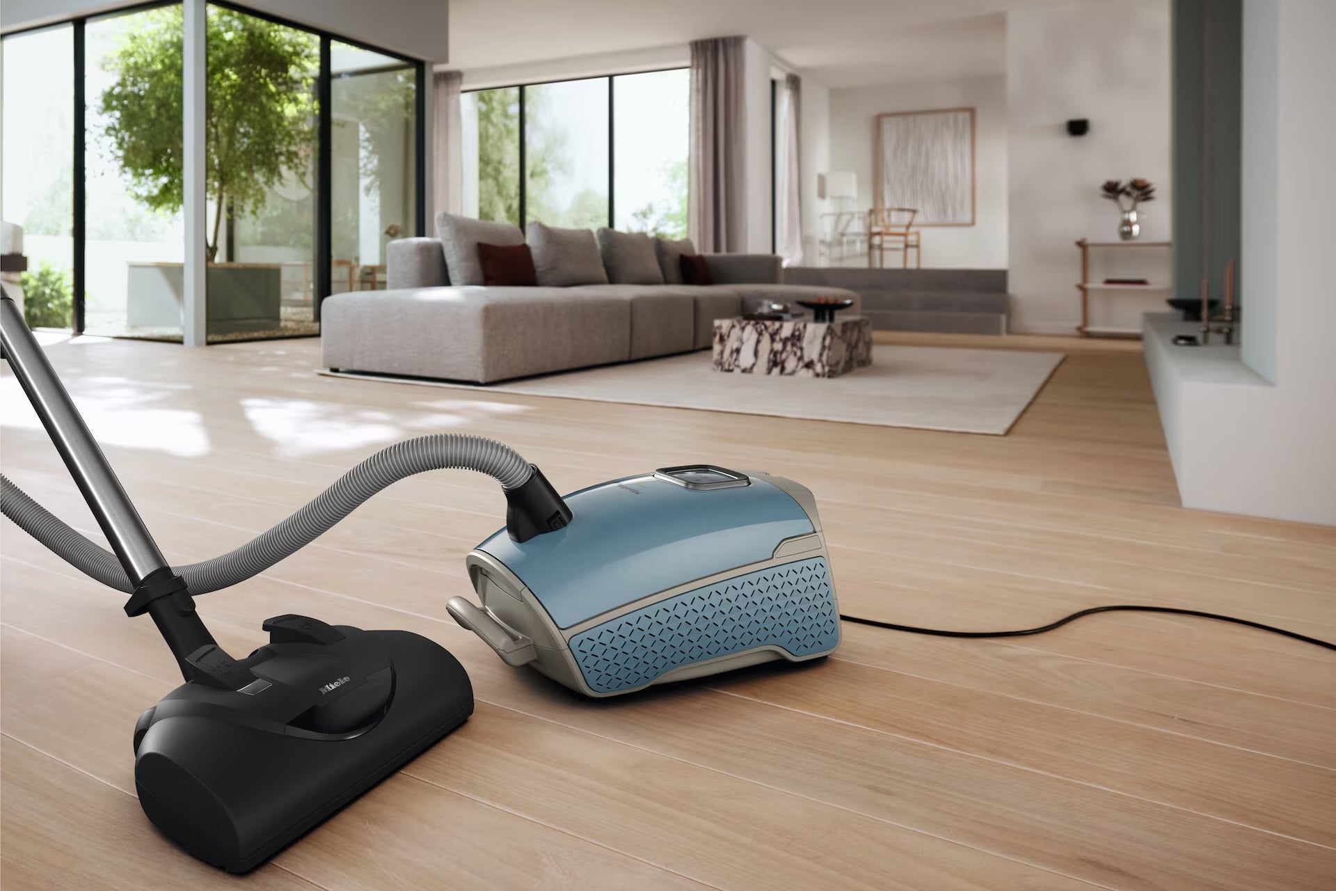 Miele Guard L1 Nordic Blue Front Vacuum cleaner on a wooden floor in a modern living room