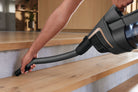 Miele HX-FCT 10 Triflex cleaning kit Hose cleaning pet hair from  wood stairs with a concrete background 