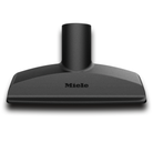 Black upholstry nozzle canister vacuum attachment with Miele logo on a white background