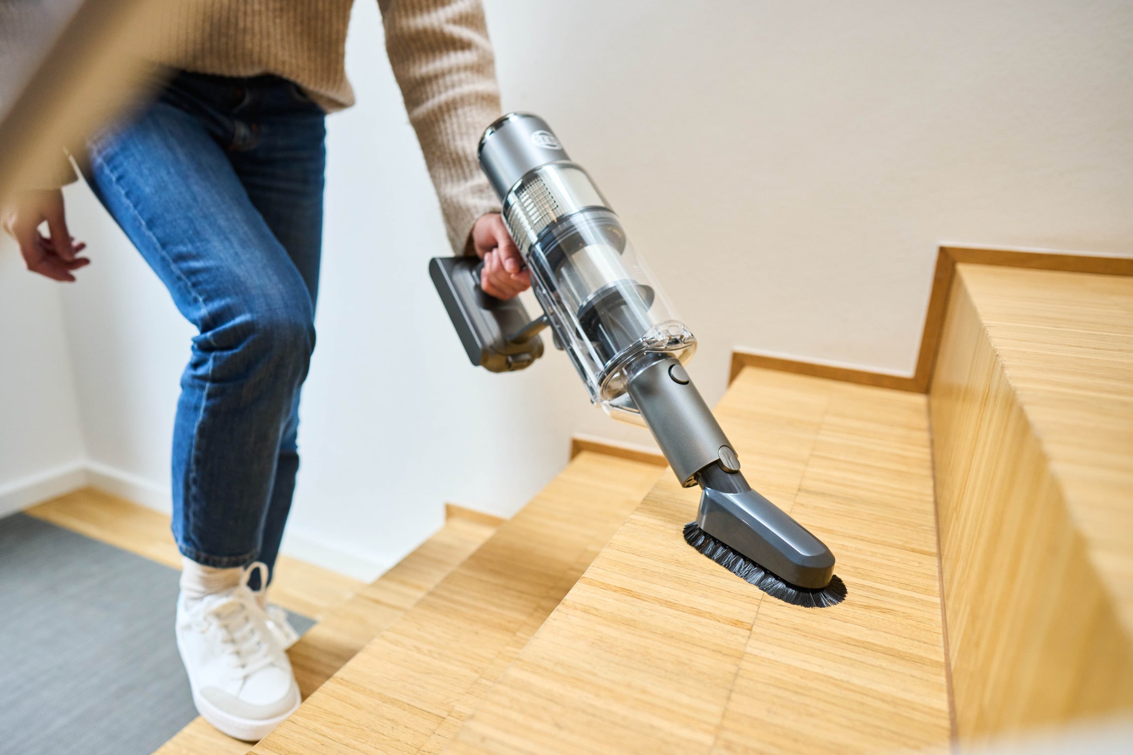 SEBO BALANCE A1 cordless stick vacuum in handheld mode with dusting brush to clean stairs and walls