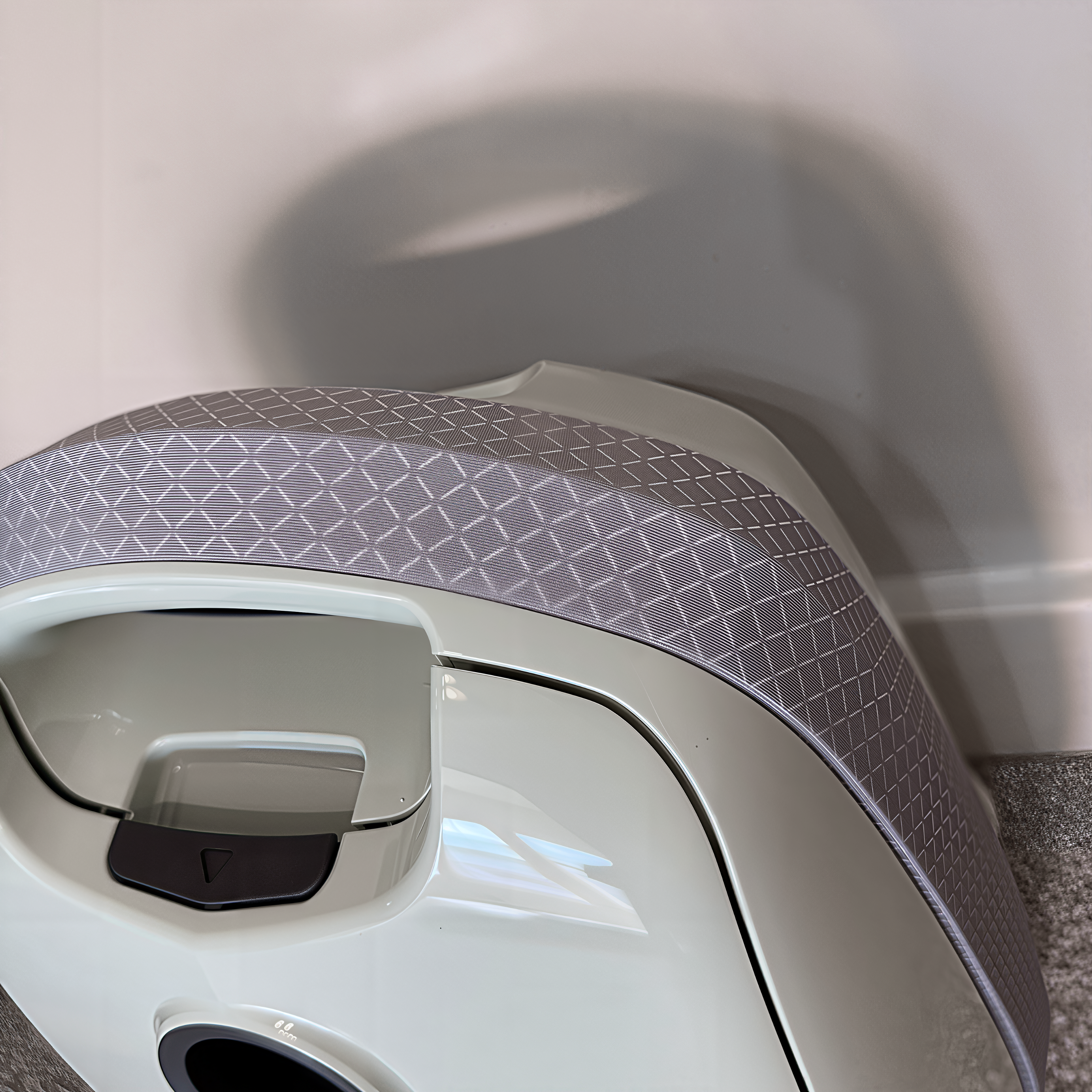 Close-up of the textured bumper that wraps around a mint Sebo E3 Premium canister