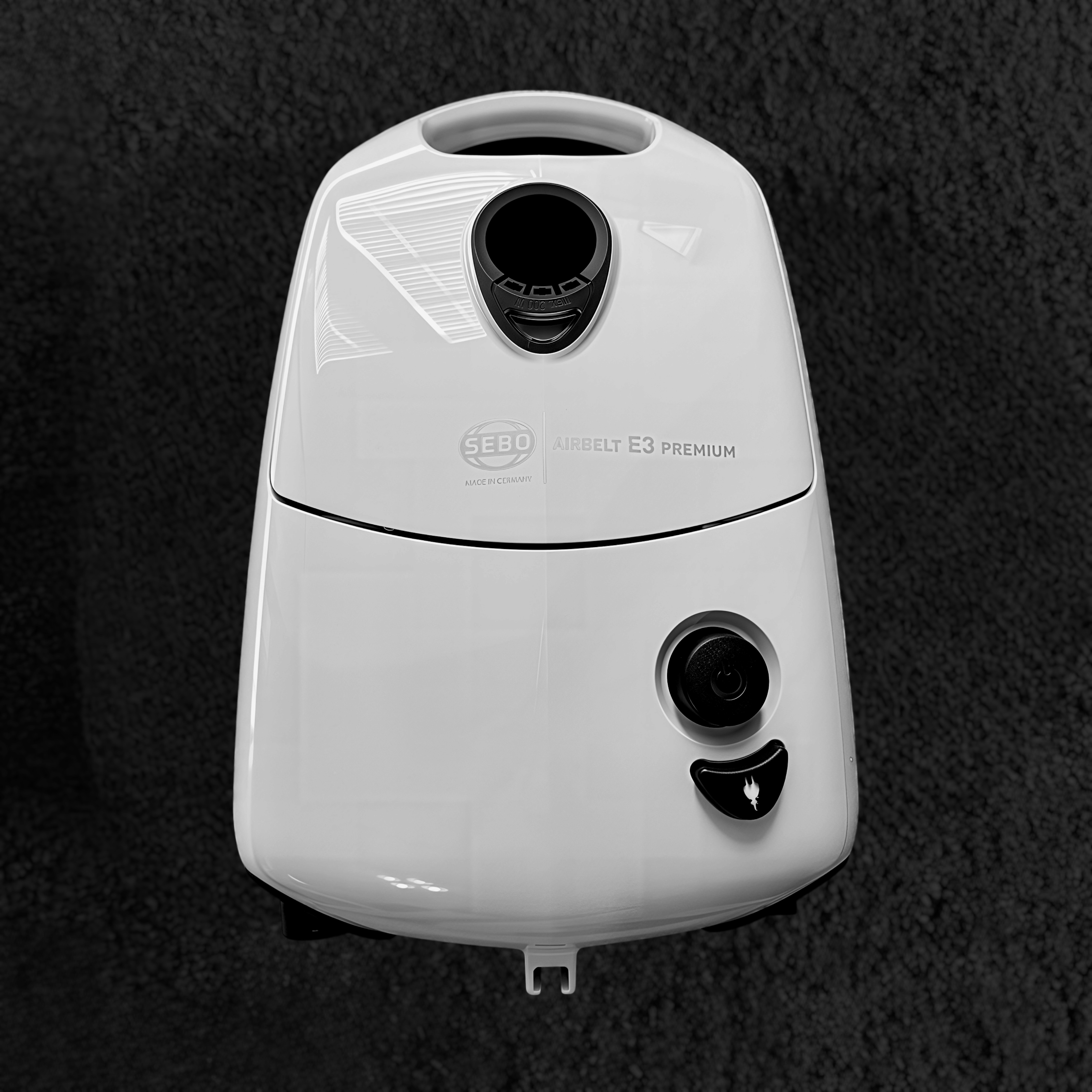 White Sebo E3 Premium canister on a black shag rug