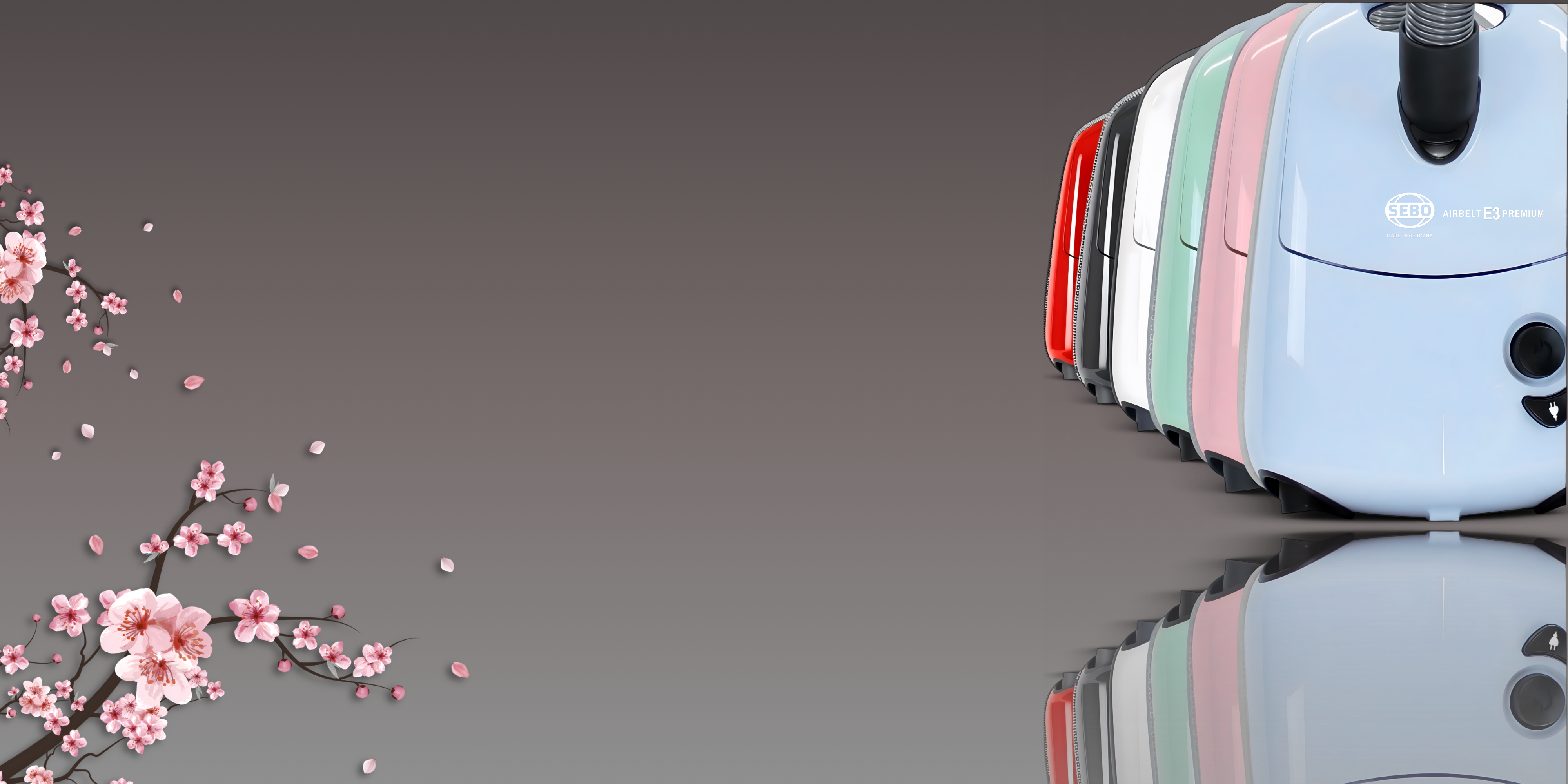 Sebo e3 canister vacuums in blue pink mint green white grey and red with cherry blossoms