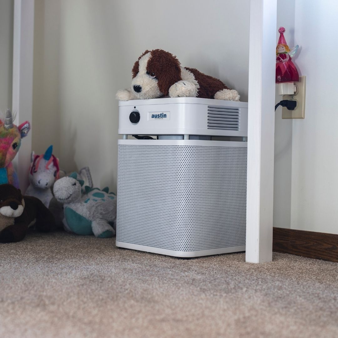 Austin Air HealthMate Plus Junior with a plush toy on top in a child's room