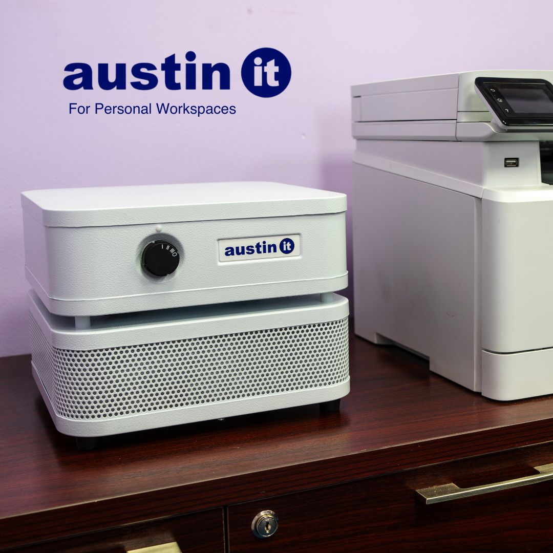 Austin Air “it” on a desk against a purple wall