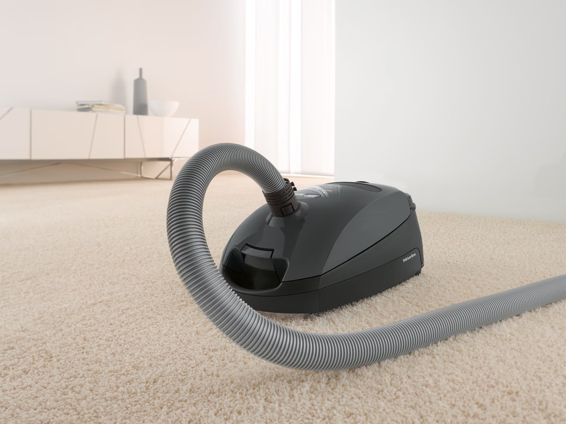 Miele Classic C1 Pure Suction in Graphite Grey in a living room.