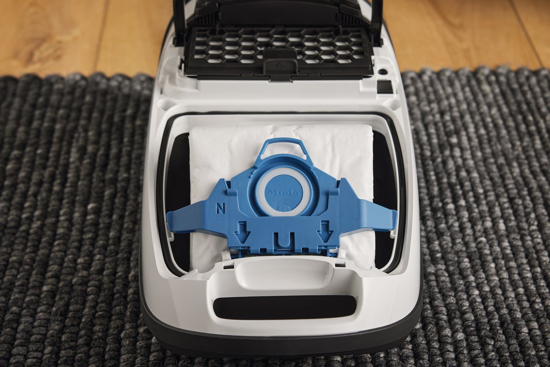 Miele GN dustbag installed in an open canister vacuum.