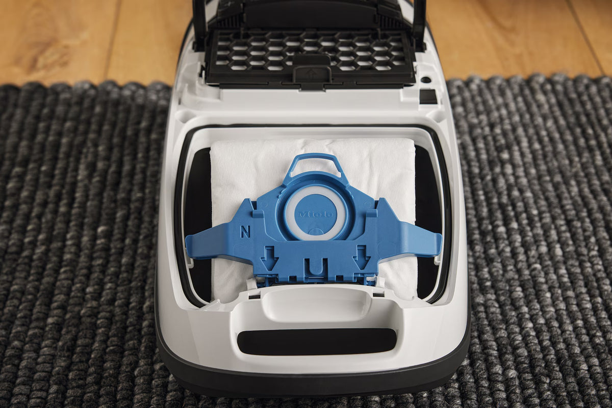 Miele GN dustbag installed in an open canister vacuum.