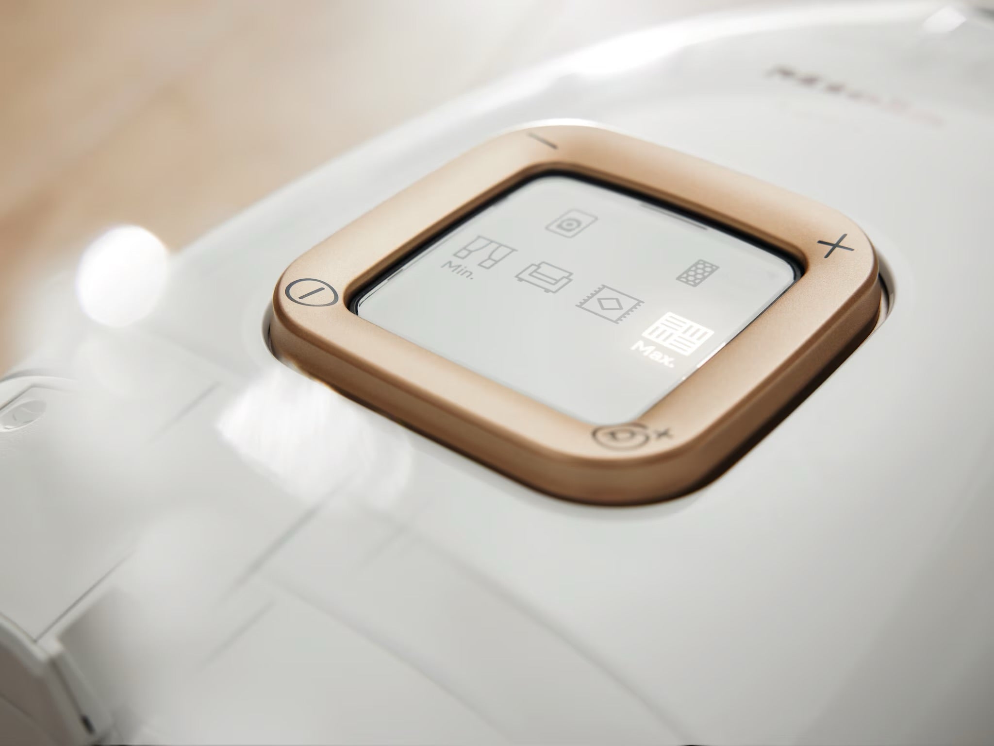 Plus and minus foot controls on top of the Miele Guard canister.
