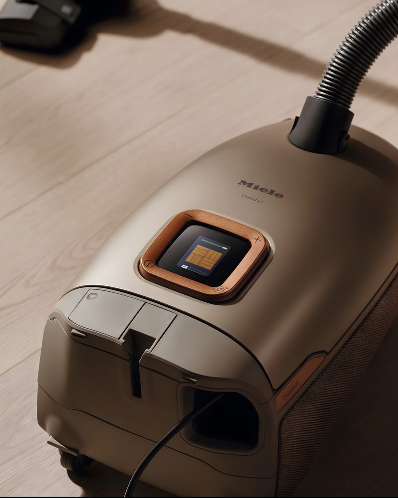Miele Guard L1 canister vacuum with color display on a hardwood floor