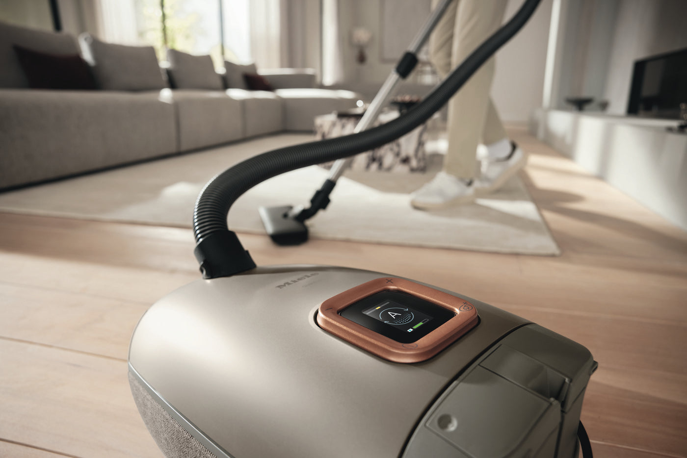 Close-up of the Miele Guard L1 Electro in Titanium on a wood floor.