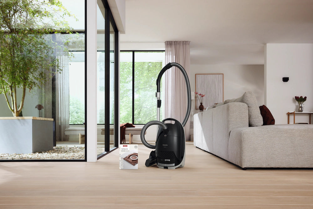 Miele Guard M1 canister in a bright living room.