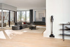 Miele Triflex HX3 Hardfloor in Casa Grey standing in its park position in a sunlit living room.