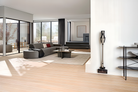 Miele Triflex HX3 Plus in Titanium Pearlfinish on its wall-mounted charging bracket.