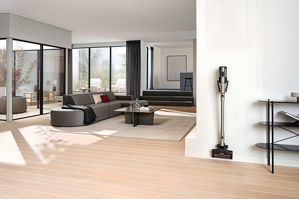 Miele Triflex HX3 Plus in Titanium Pearlfinish on its wall-mounted charging bracket.