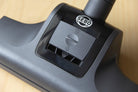 Close-up of the SEBO turbo head floor nozzle for the Airbelt K2 Turbo canister vacuum, shown on a hardwood floor.