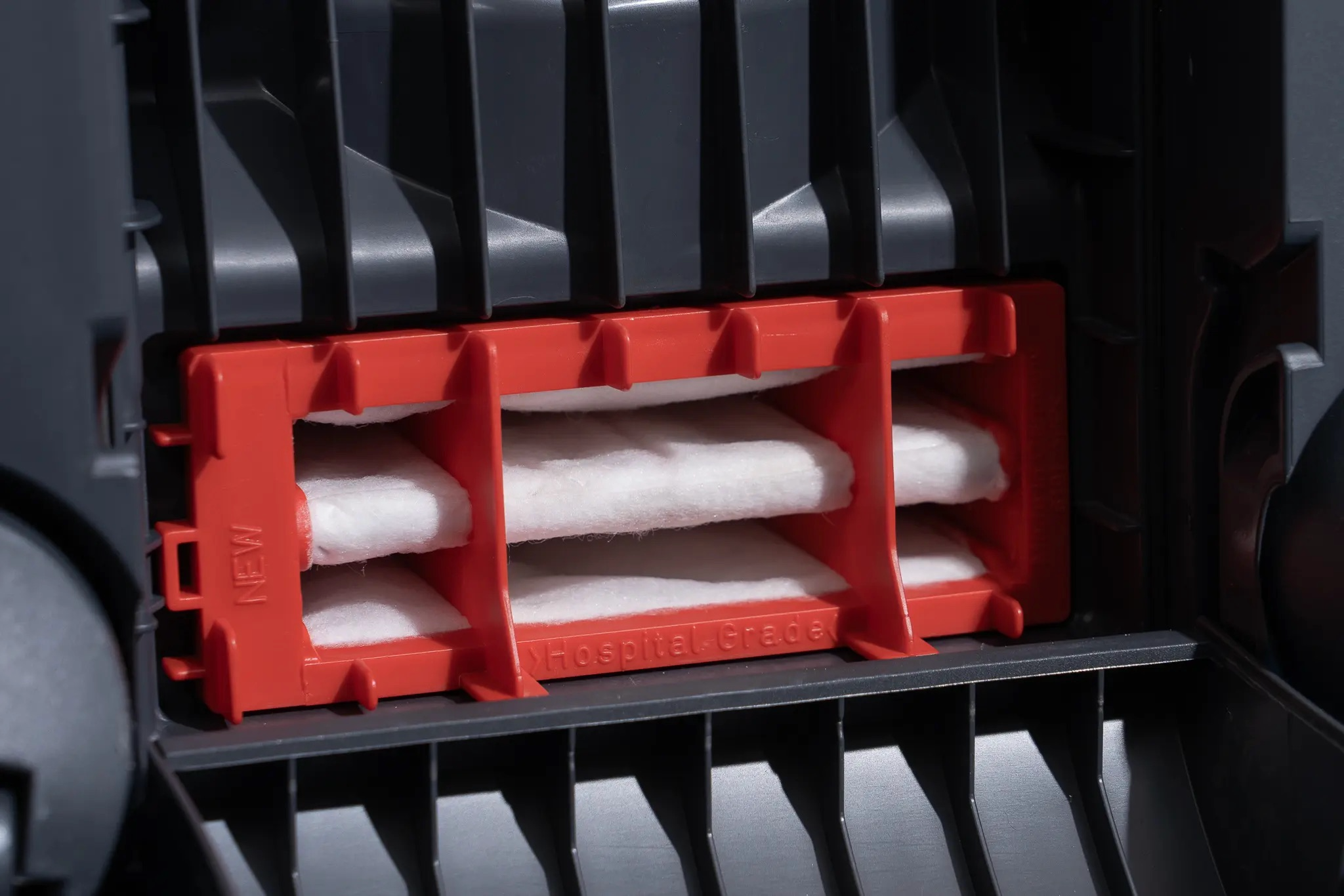 Close-up of the red internal HEPA filter foam inside the SEBO Airbelt K3 Premium canister vacuum.