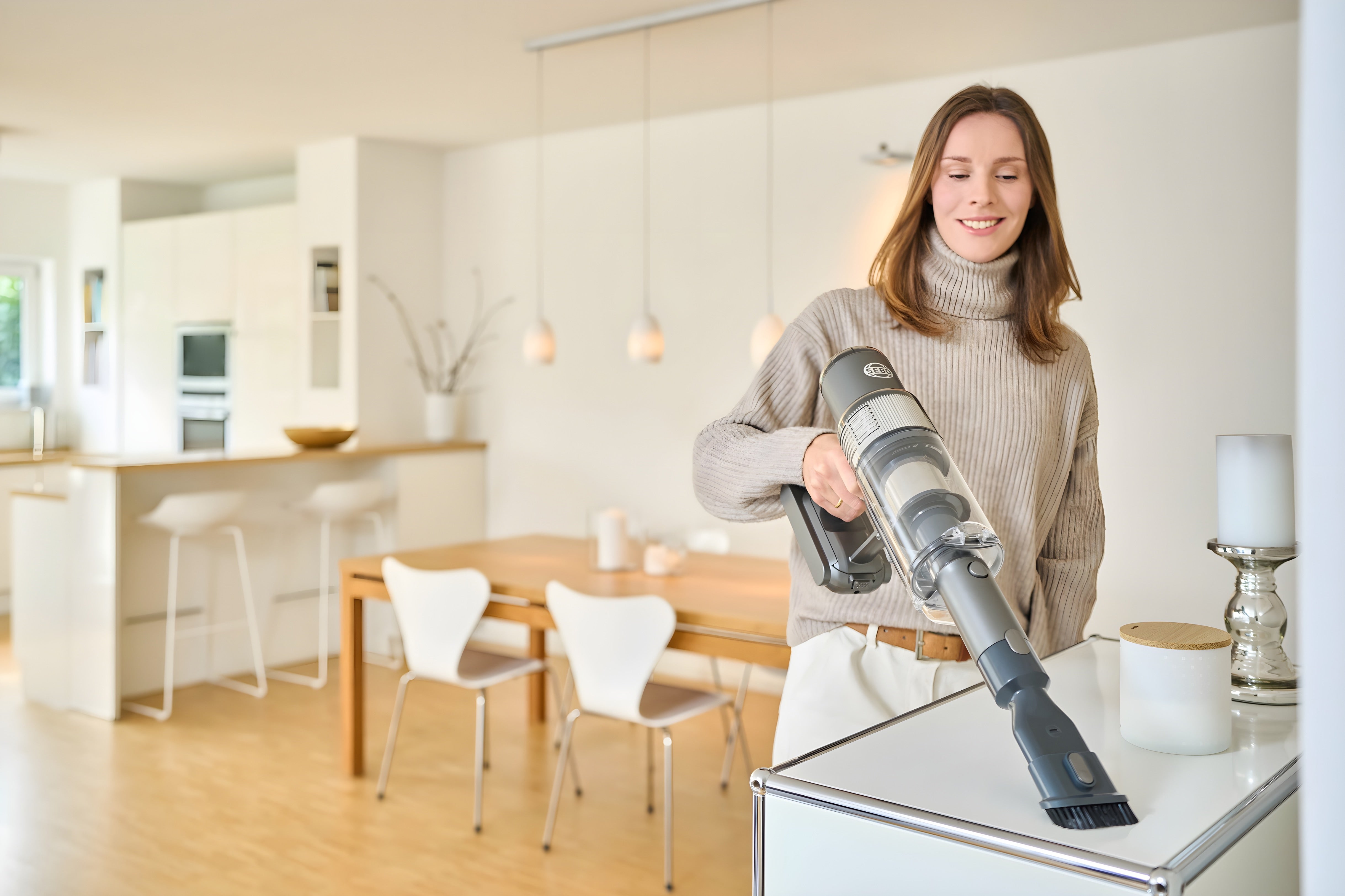SEBO Balance A1 in handheld mode with dusting brush on a table.