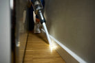 SEBO Balance A1 light-up crevice tool along a baseboard.
