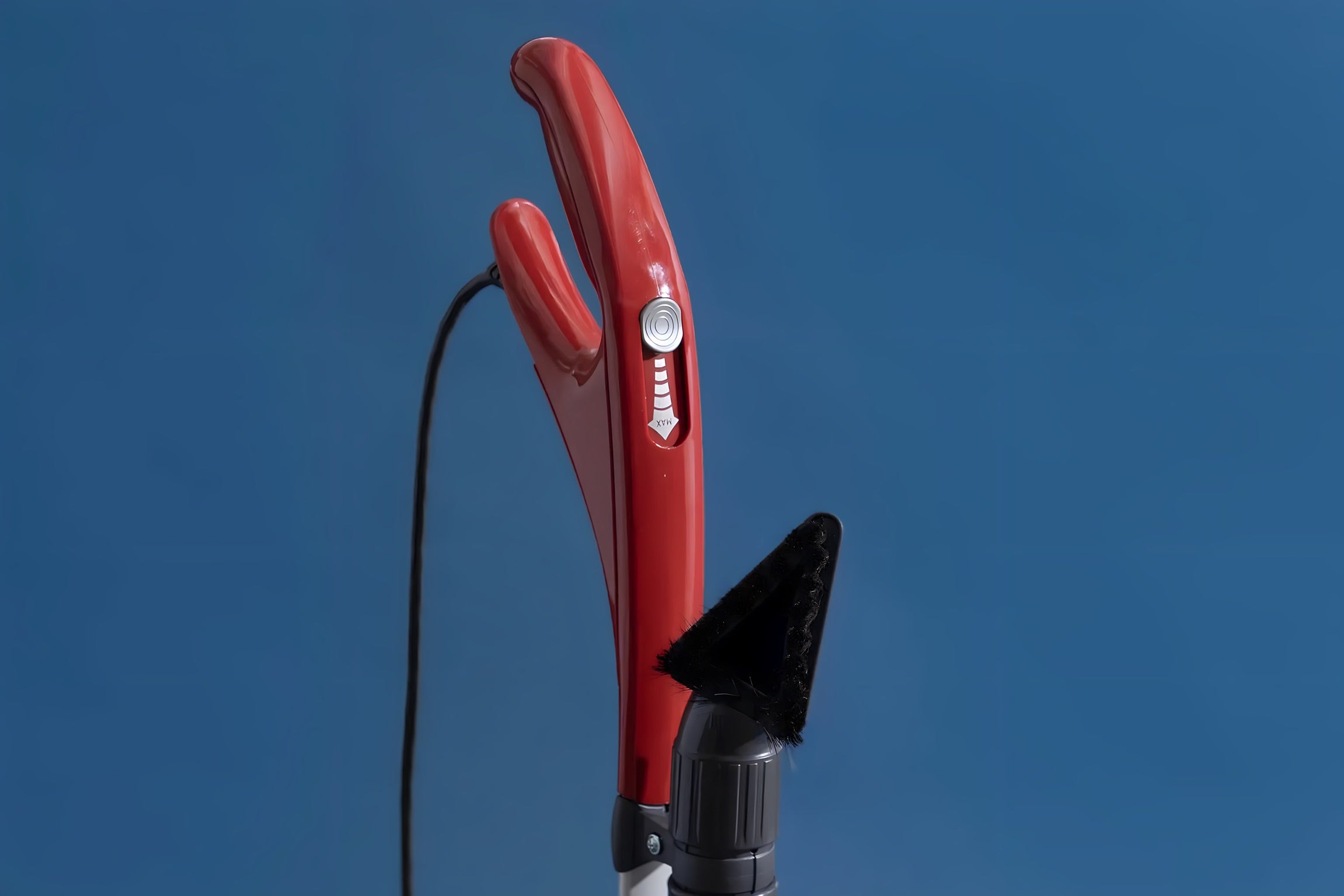 Red SEBO Felix Premium detachable handheld suction unit, shown against a blue background.